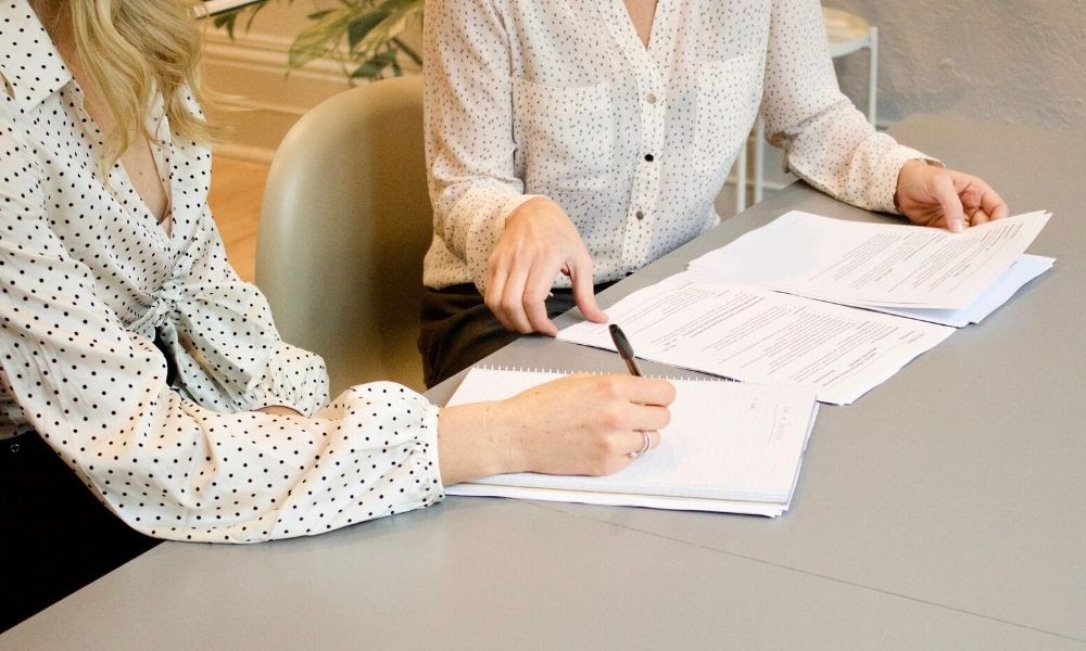 Image of professionals looking over paperwork and taking notes. 